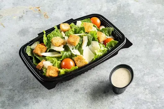 Caesar salad with croutons and parmesan, packaged for takeout