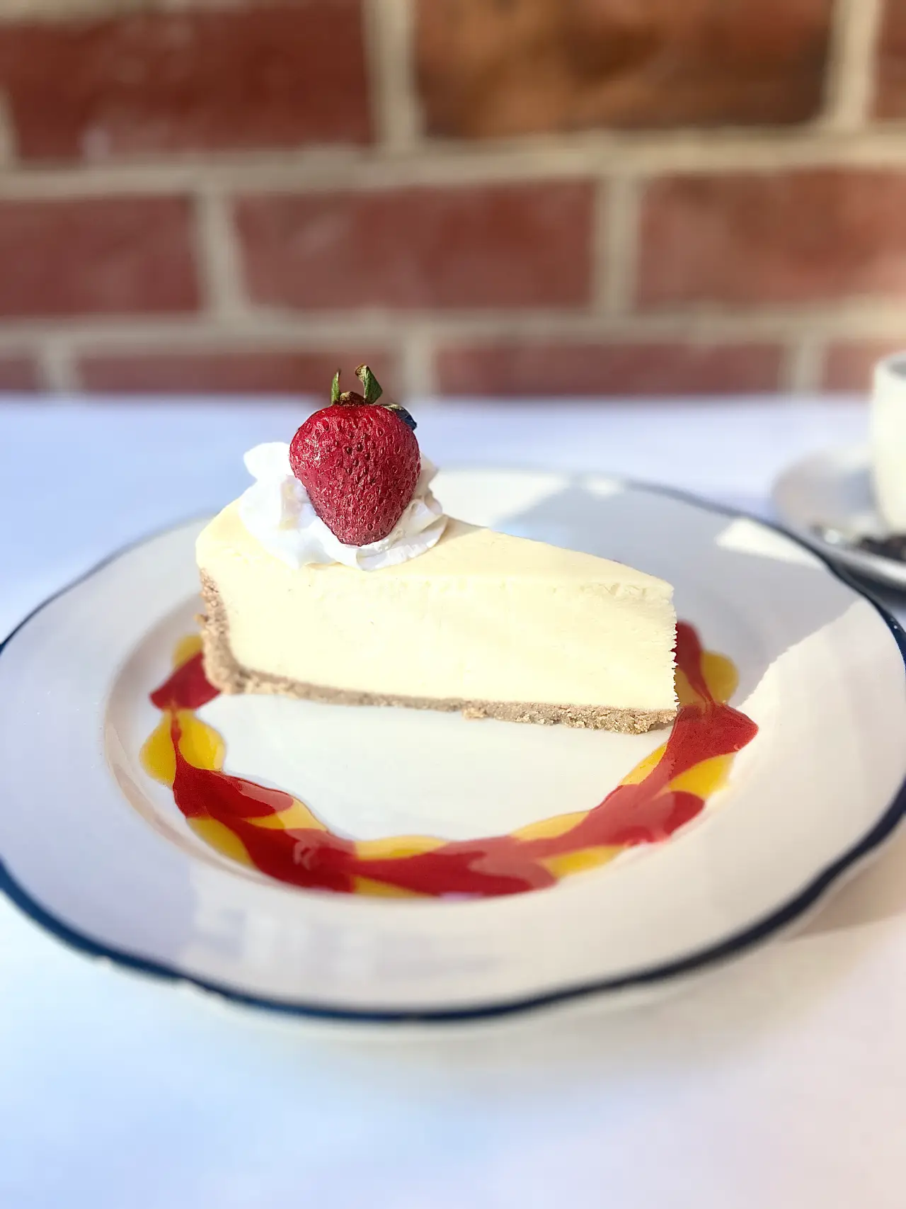 Slice of mango passion fruit cake with berry garnish