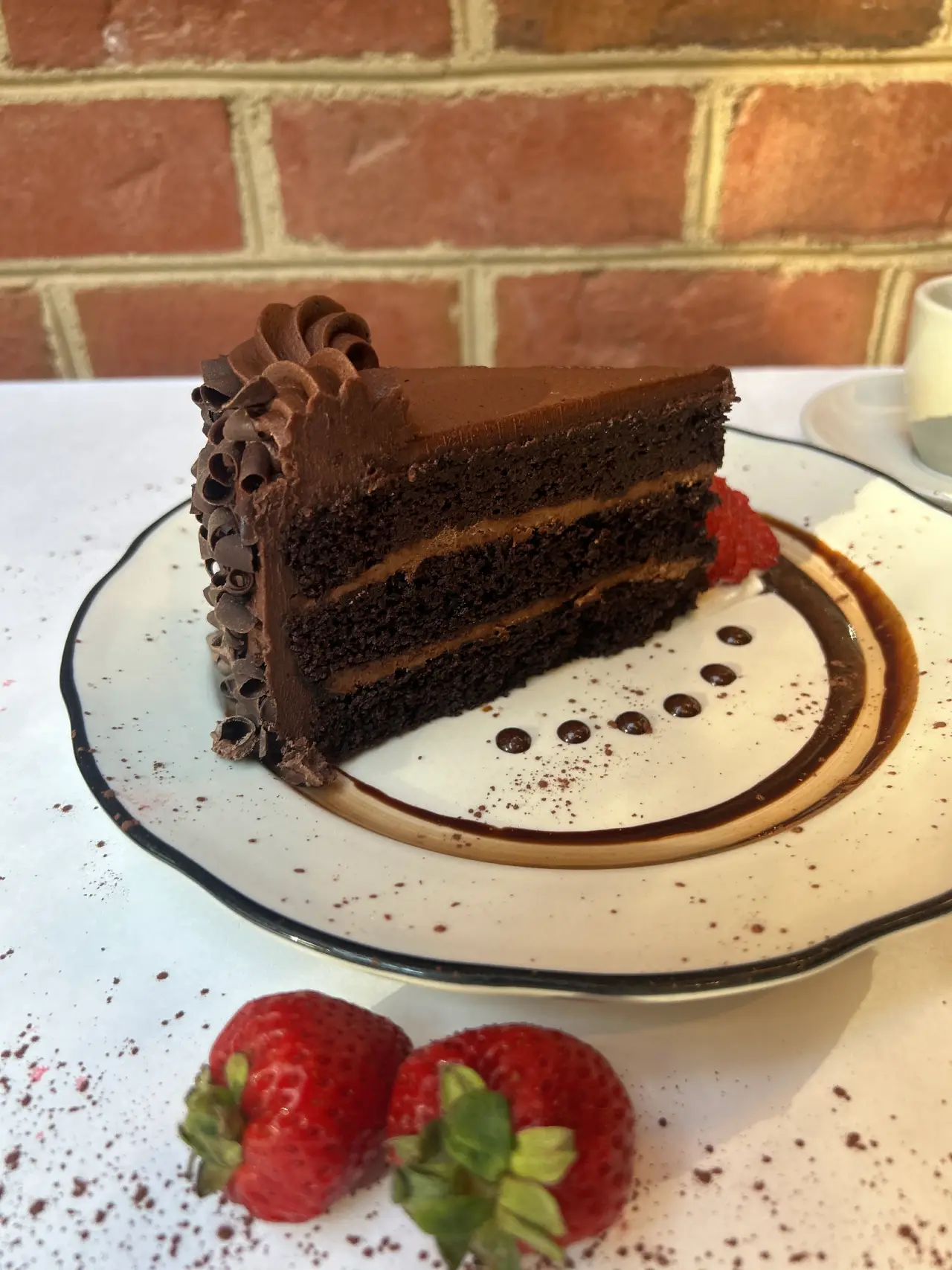 Slice of double chocolate cake with chocolate ganache