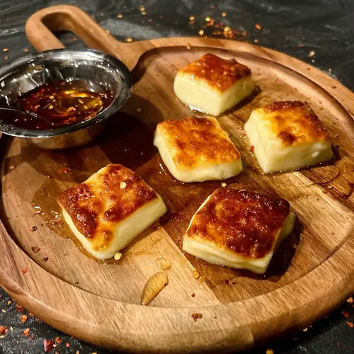 Dulce de leche squares served with caramel sauce