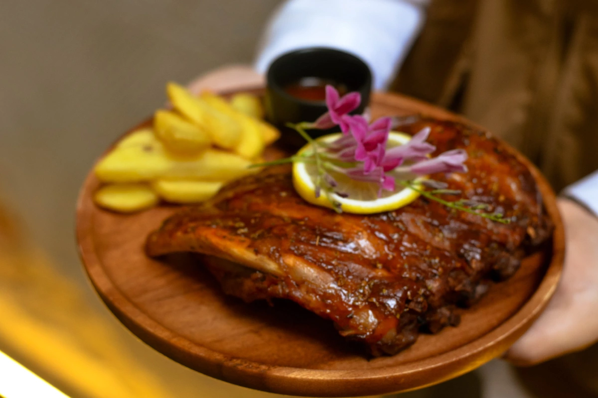 Slow-roasted leg of lamb served with lemon